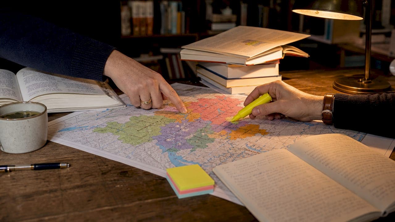 Close-up of hands pointing at Swiss linguistic map